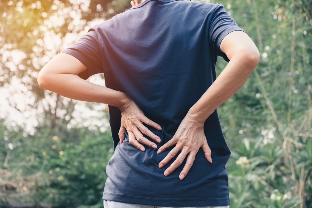 Closeup,Hands,Of,Woman,Touching,Her,Back,Pain,In,Healthy